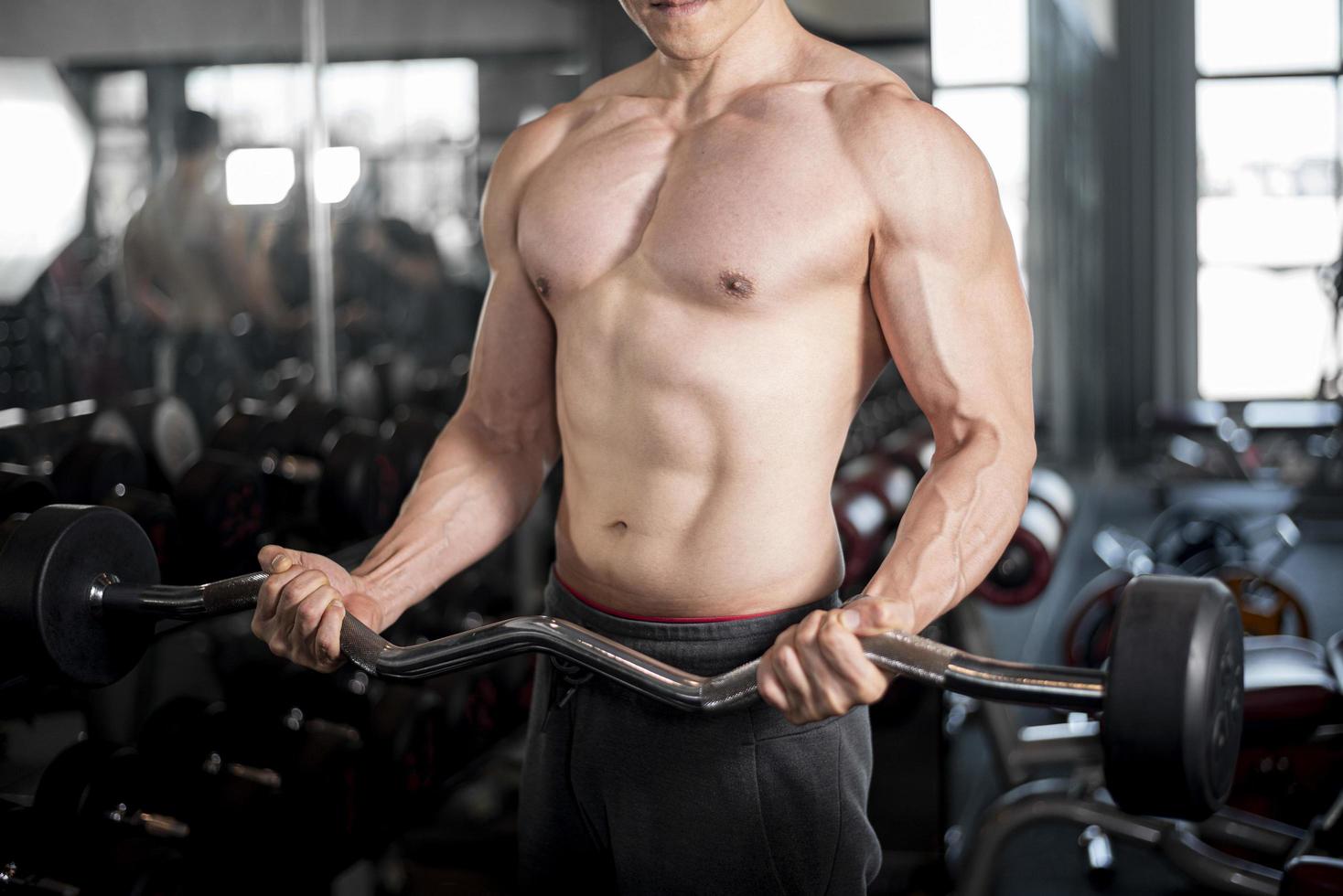 Close up muscular man is exercise in fitness gym photo