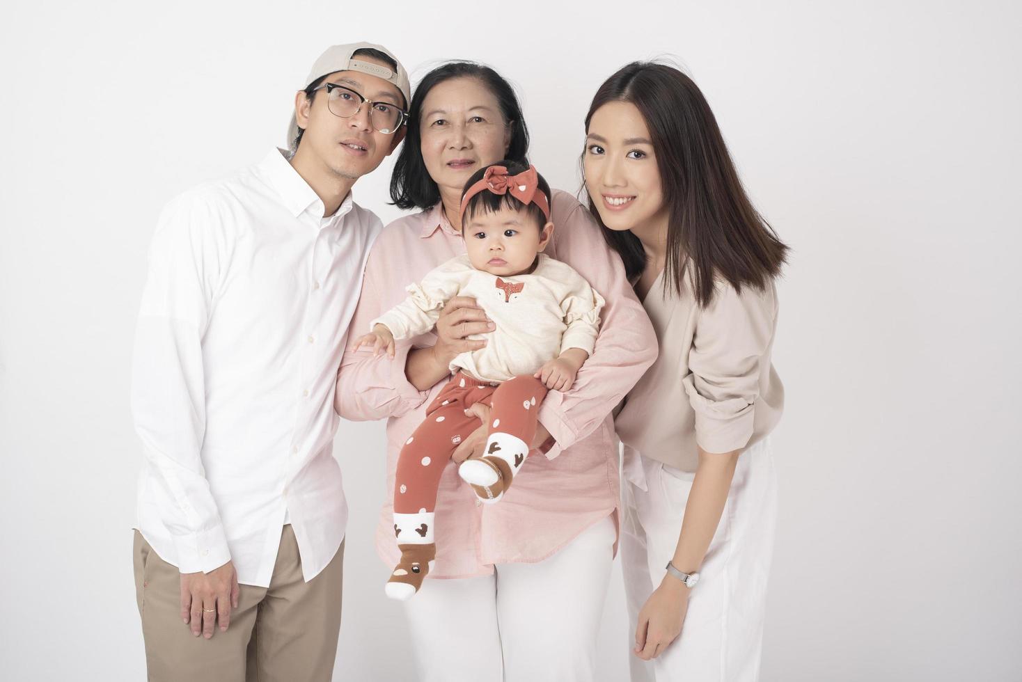 Happy Asian family on white background photo