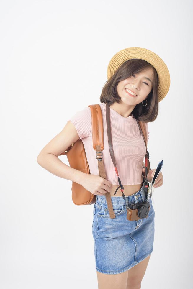 Beautiful young asian tourist woman happy on white background studio photo