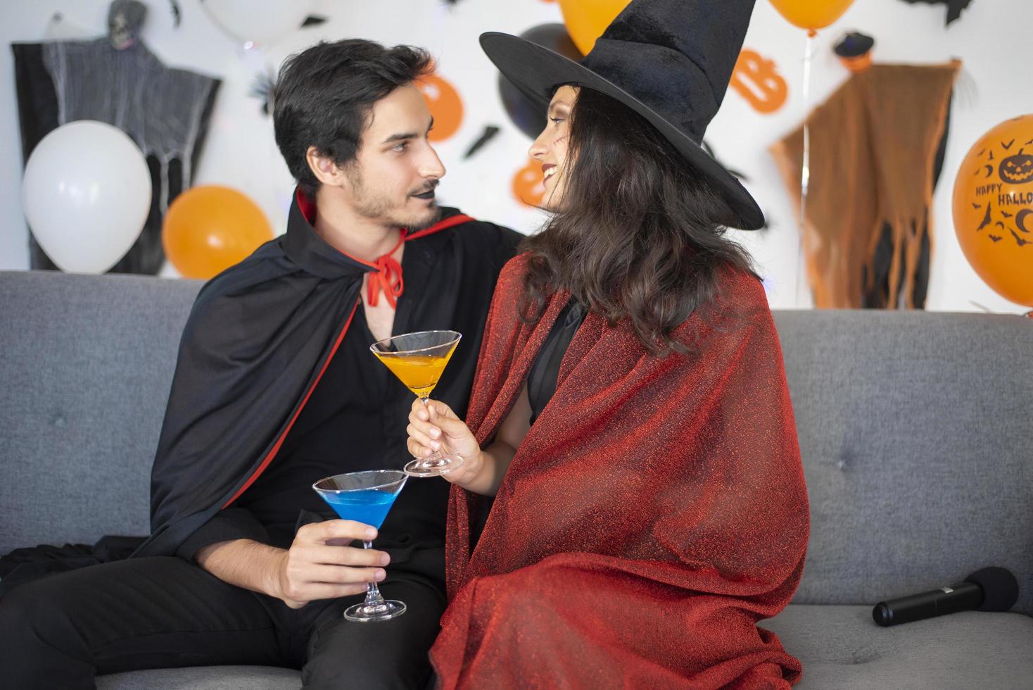 happy couple of love  in costumes and makeup on a celebration of Halloween photo