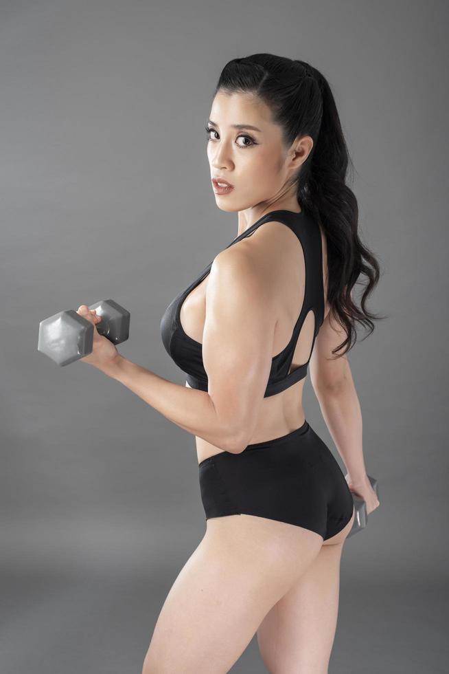 Beautiful fitness body builder woman in Studio photo
