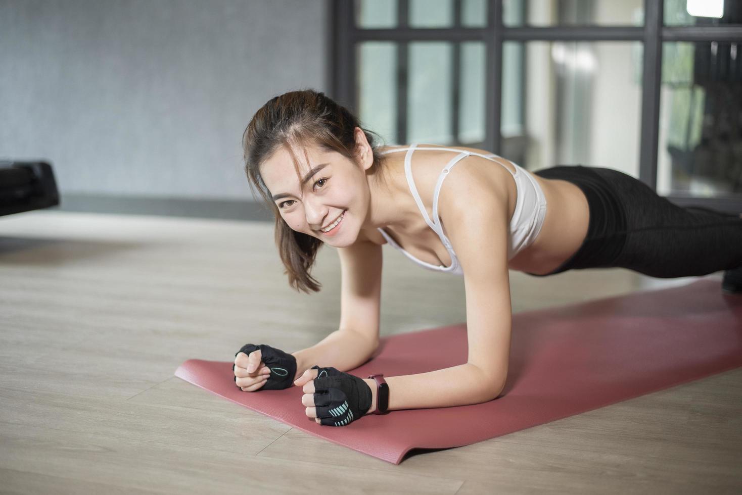 Beautiful asian woman is doing exercise in the gym photo