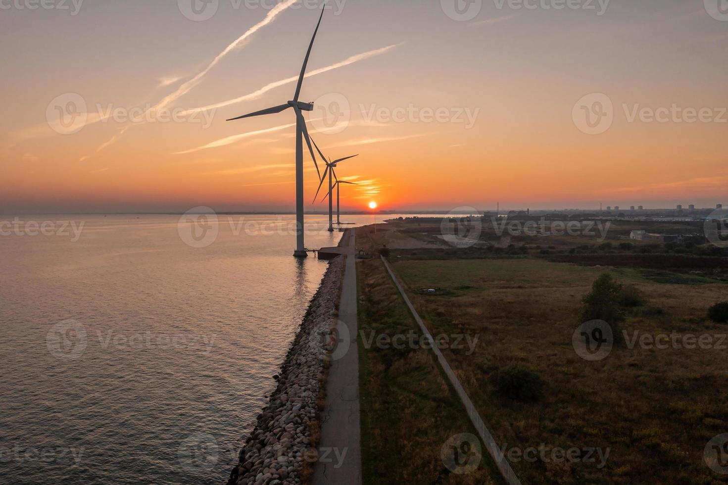 Aerial view of the wind turbines. Green ecological power energy generation. Wind farm eco field. Offshore and onshore windmill farm green energy at sea photo
