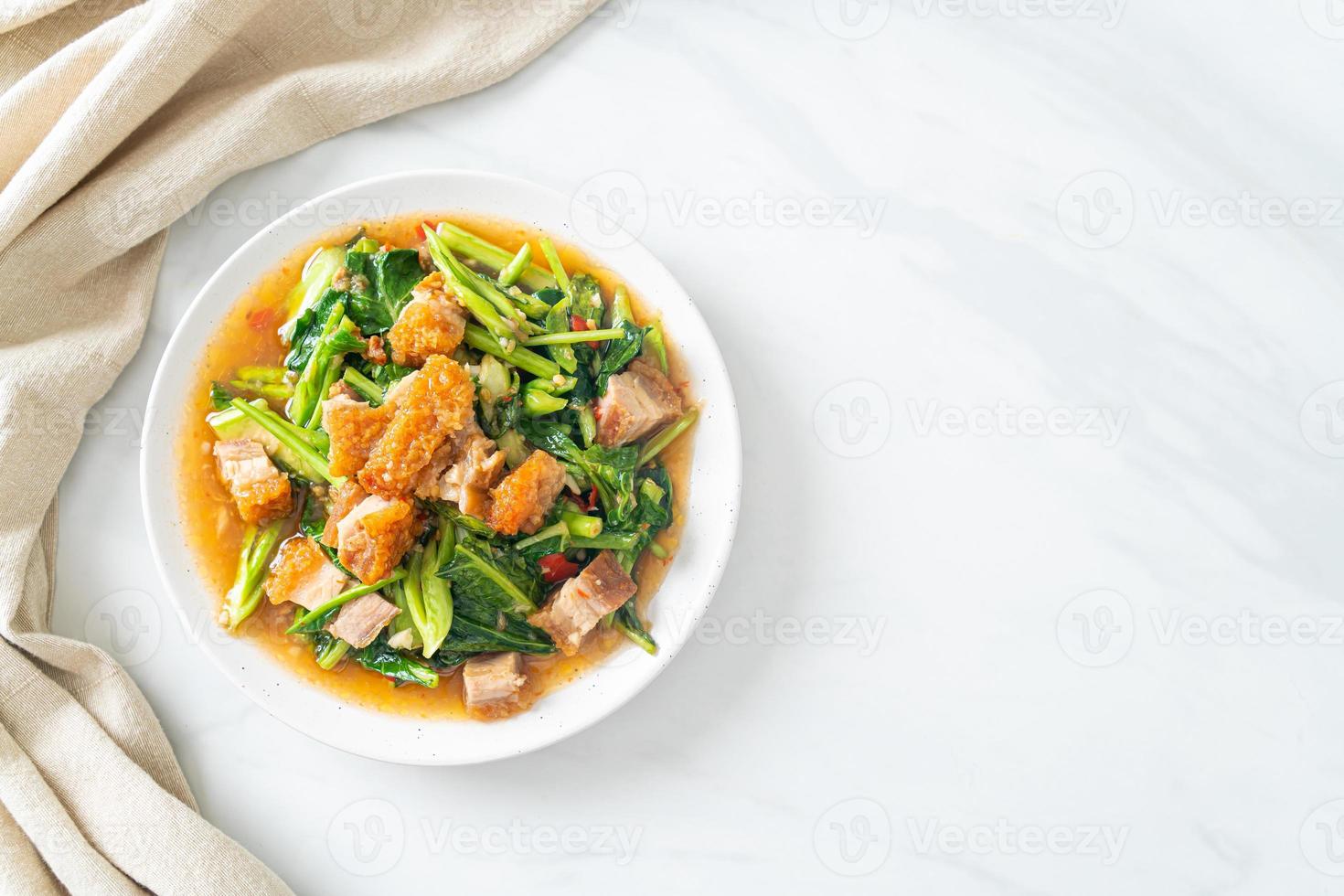 Stir-fried kale vegetable with crispy pork photo