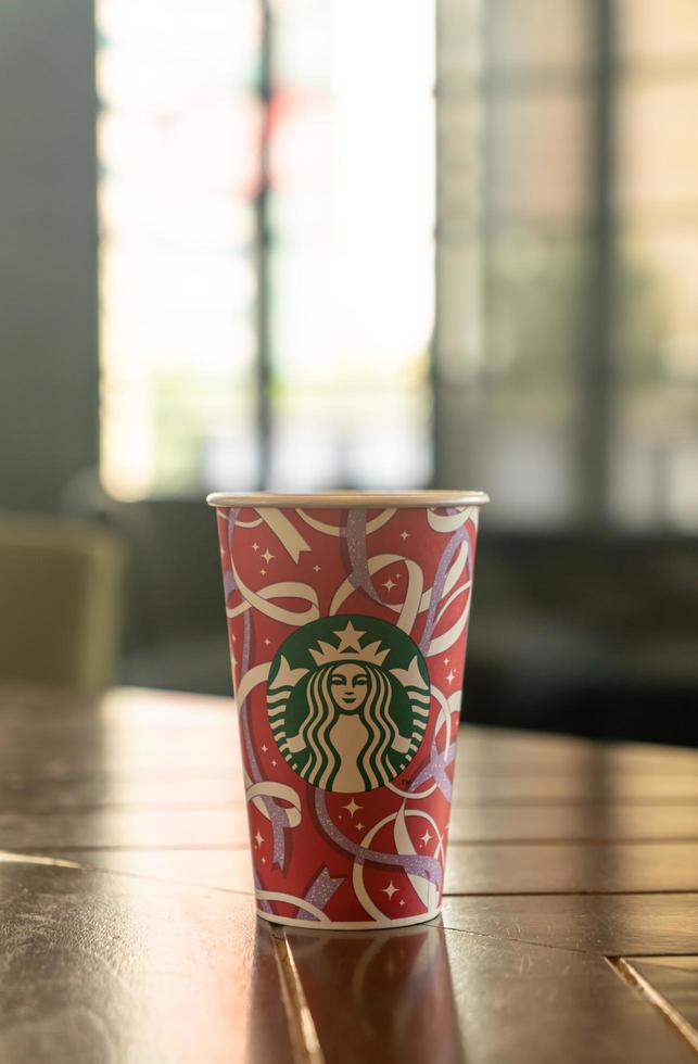 BANGKOK, THAILAND - Nov 24, 2021 - Starbucks hot beverage coffee with Christmas theme on the table. photo