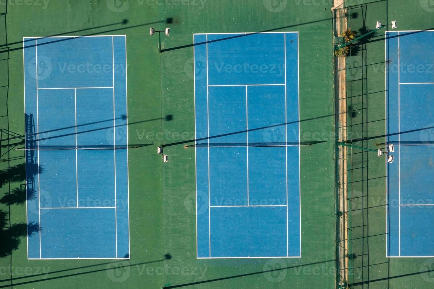 Aerial view of 2 tennis blue tennis courts. photo