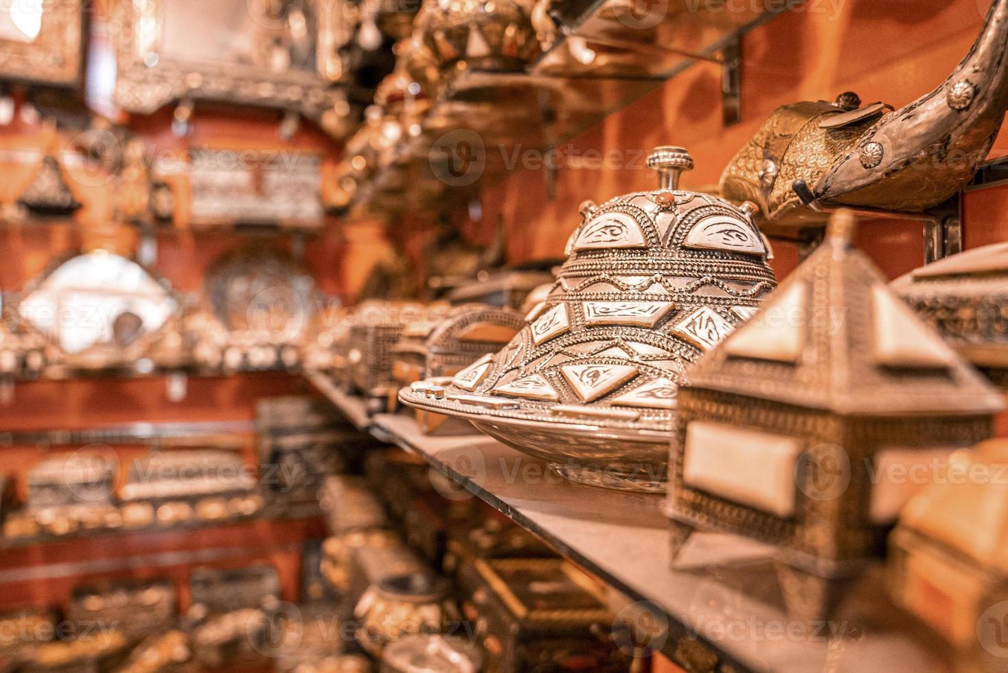 Shelf with creative moroccan souvenirs on display for selling at market photo