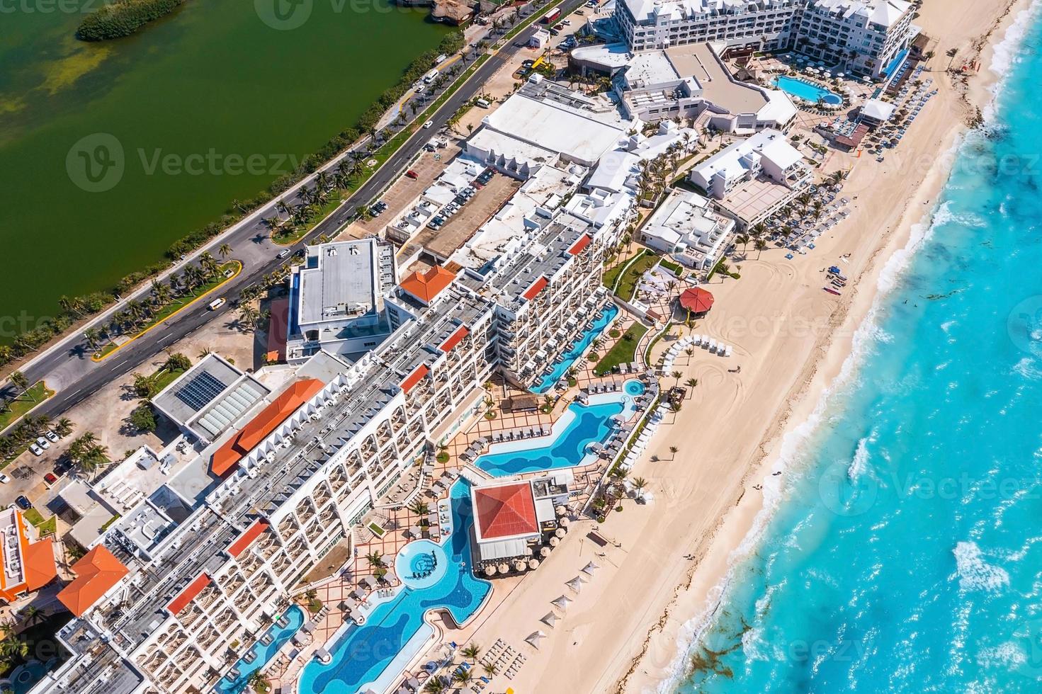 Luxury hotel with infinity pool and palms all around it. photo