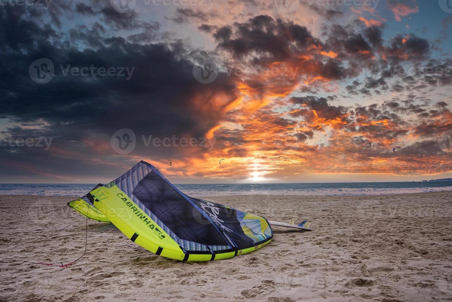 Aerial view of the kite surfers surfing in high winds in the rough sea. photo