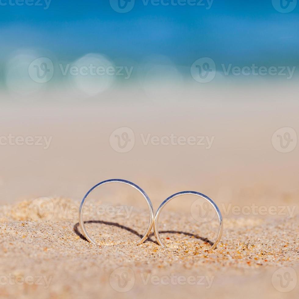 Wedding rings put on the beachside. photo