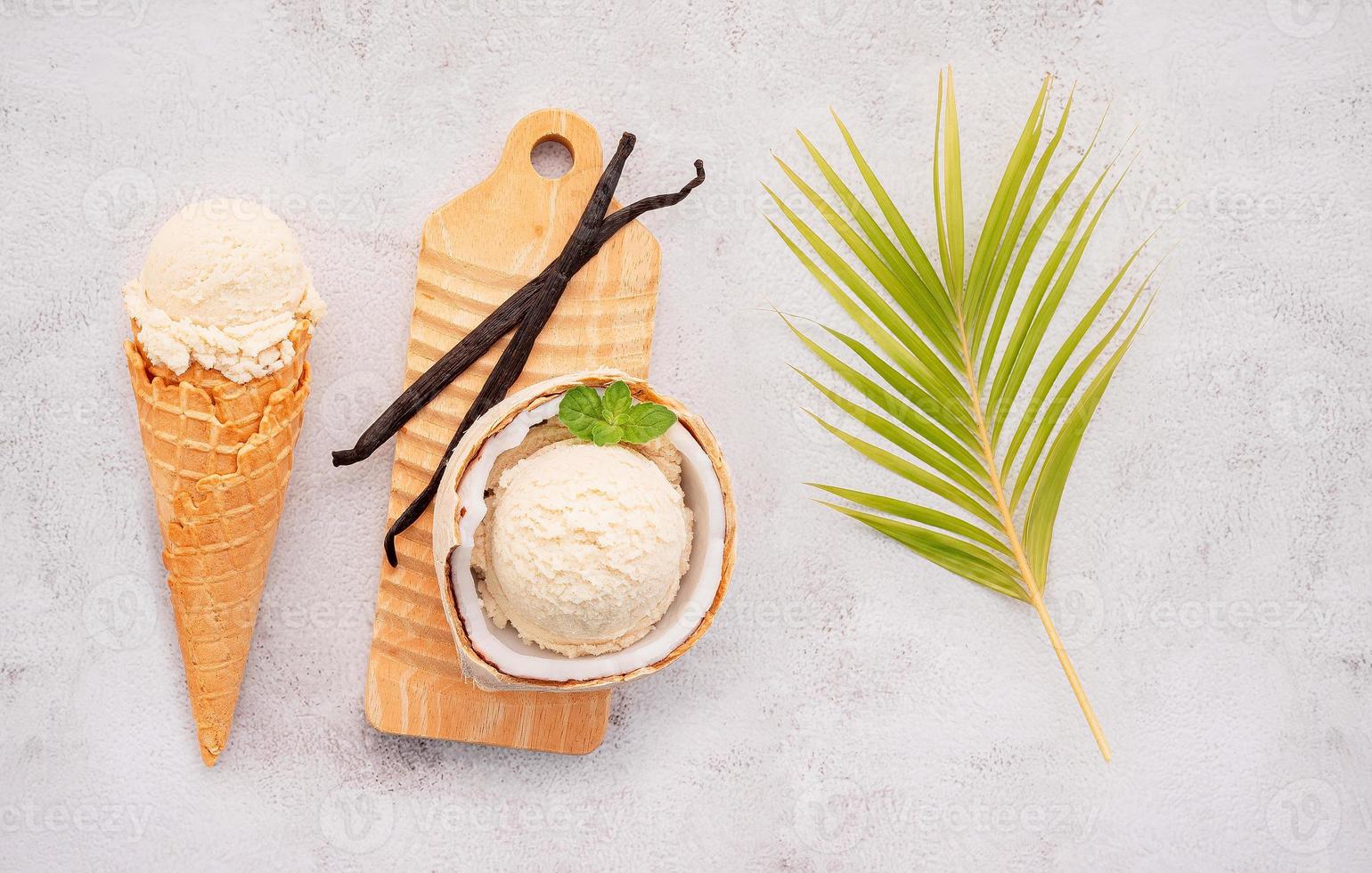 Coconut ice cream flavours in half of coconut setup on white stone background. Summer and Sweet menu concept. photo