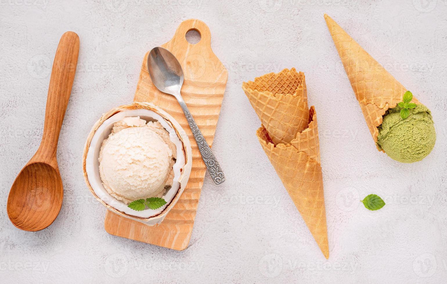 Coconut ice cream flavours in half of coconut setup on white stone background. Summer and Sweet menu concept. photo