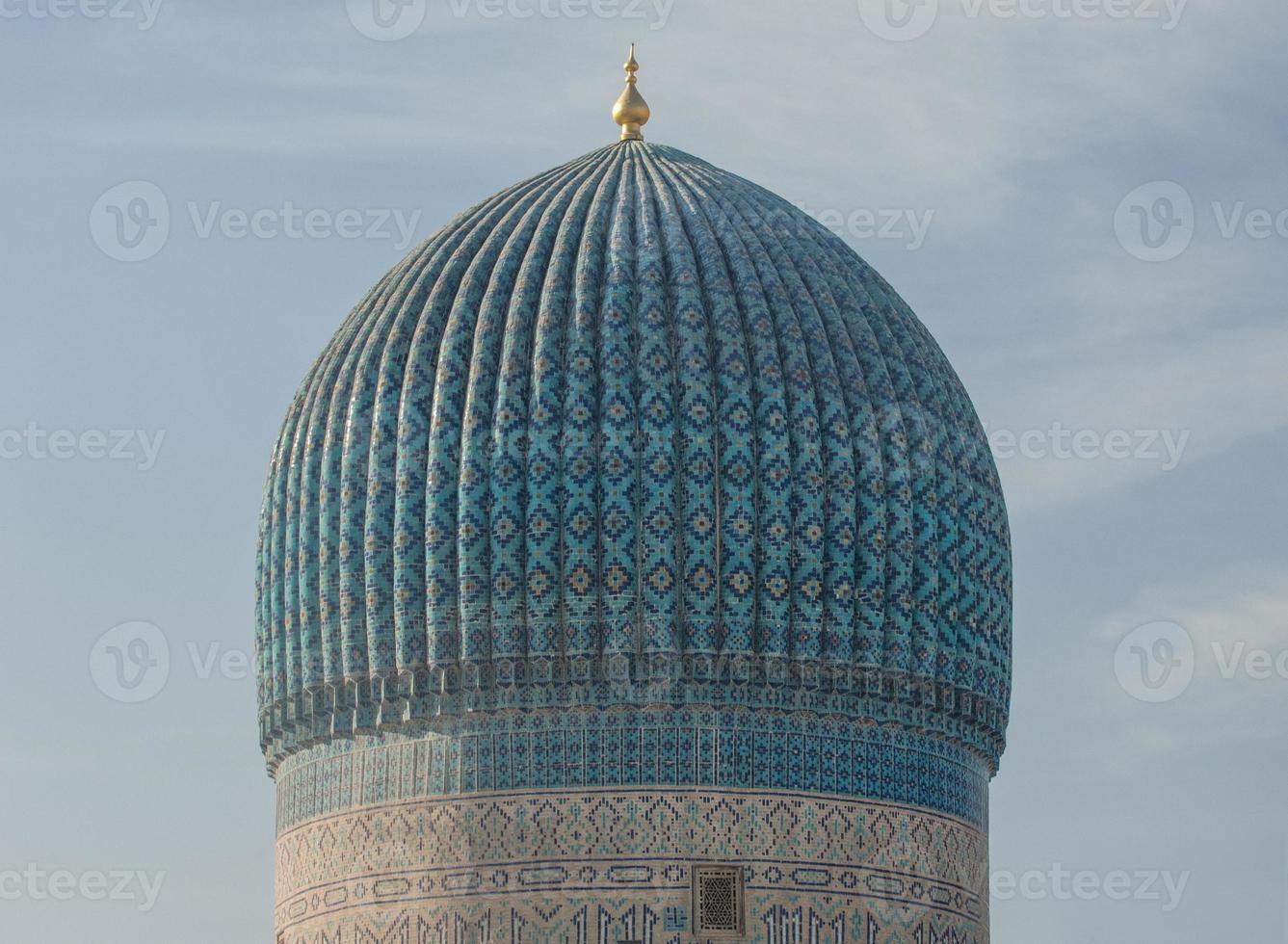 The top of the dome with tiles and mosaics. the details of the architecture of medieval Central Asia photo