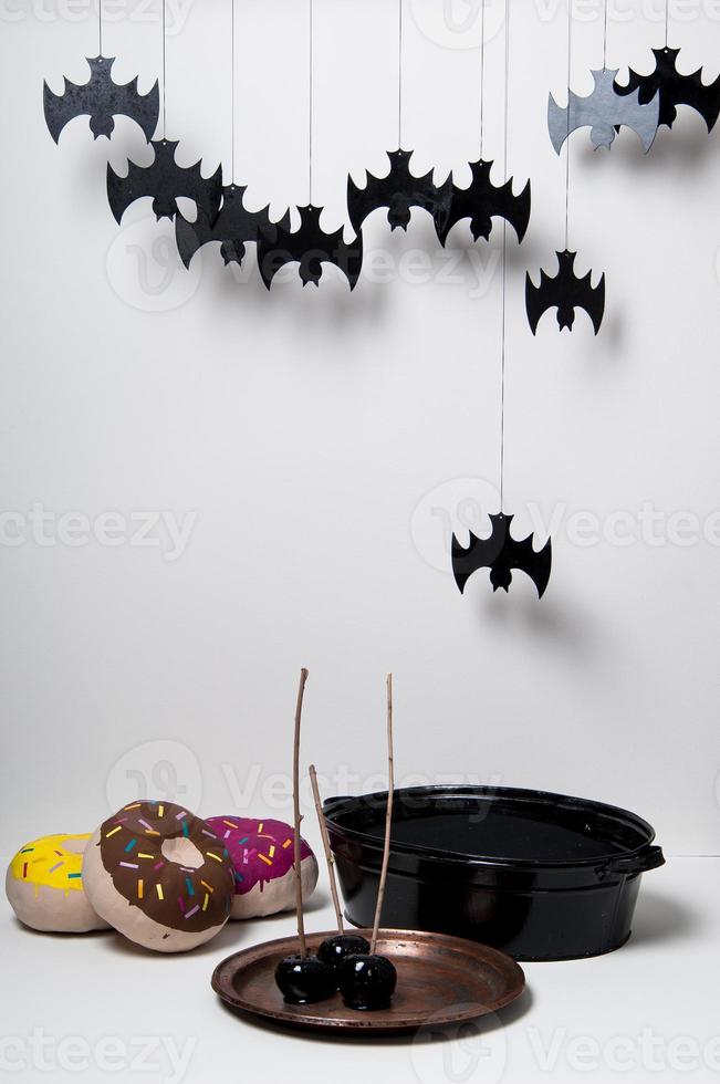 halloween with brightly painted pumpkins and bats silhouettes on a white background photo