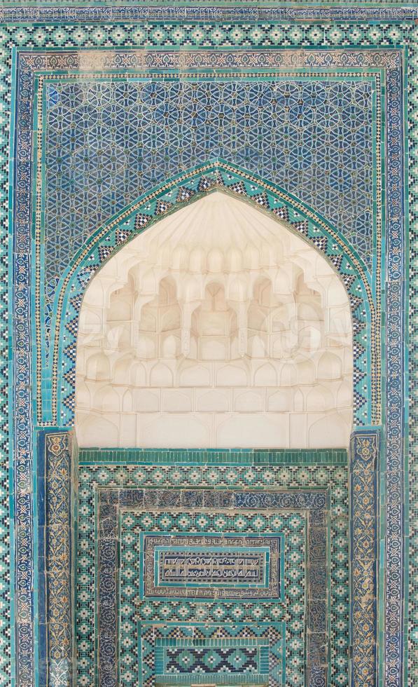 Wall with an arch and the dome in traditional Asian mosaic. the details of the architecture of medieval Central Asia photo