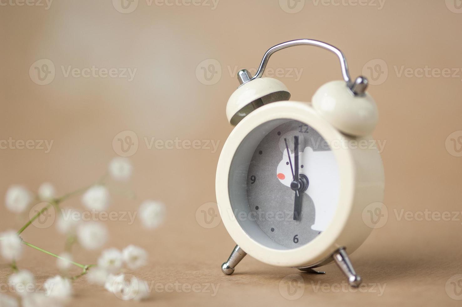 gray clock with a bear pattern on a brown blurred background photo