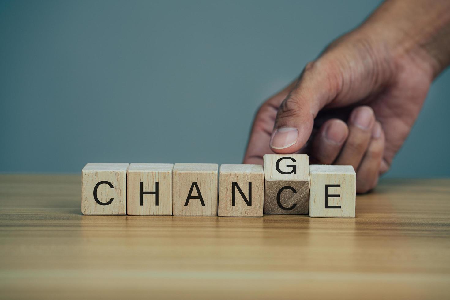 Closeup hand flips one cubes with trending the word chance to change. photo