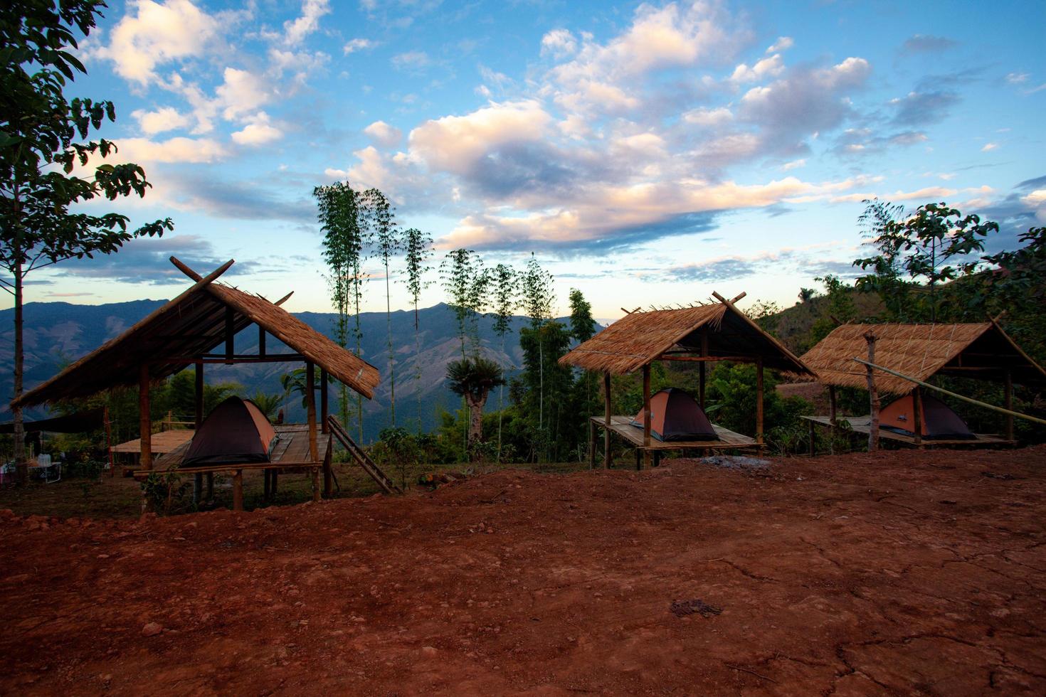 Tent pitch at Ban Piang So, Bo Kluea District, Nan Province, Thailand The tent is spread inside the hut, with a mountain view behind it. photo