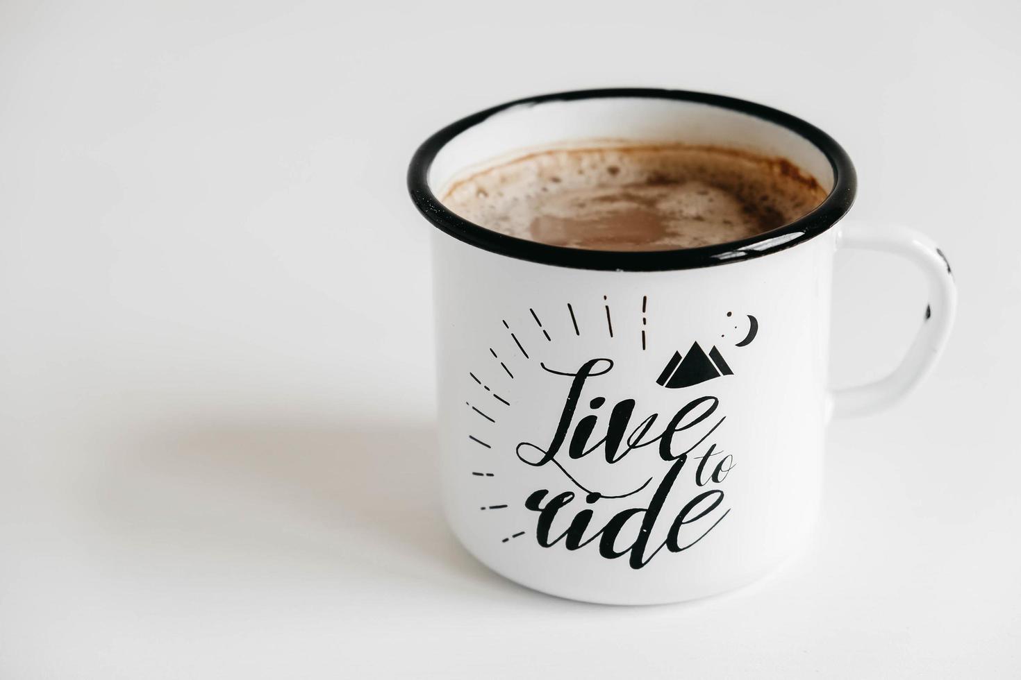 Metal mug with hot coffee on a white wooden background. Copy, empty space for text photo