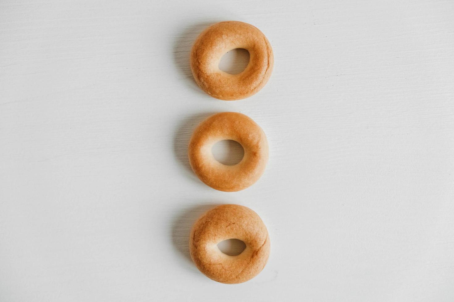 Drying or mini round bagels on a white wooden background photo