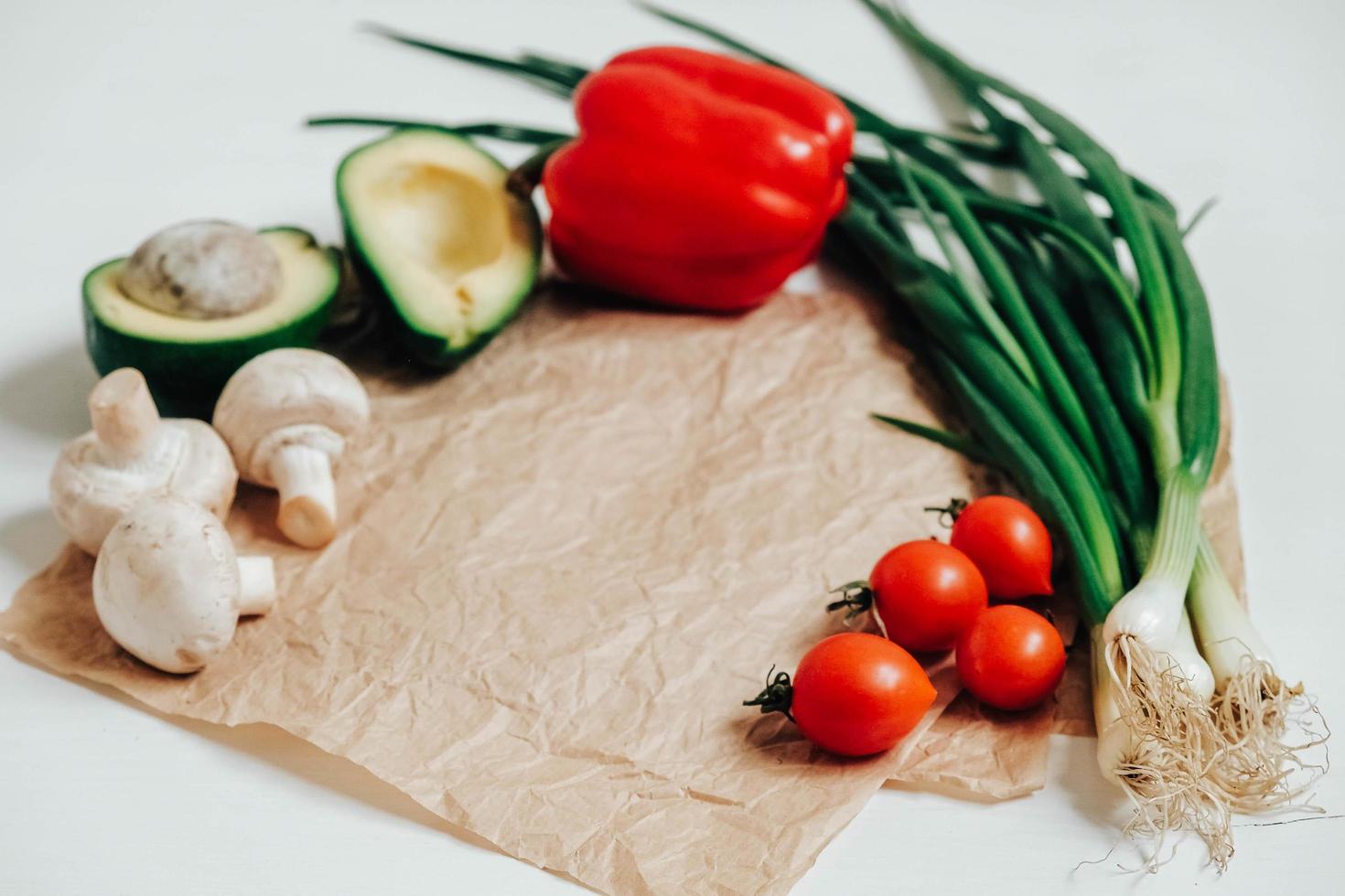 Set of different fresh vegetables on a white wooden table background. Copy, empty space for text photo