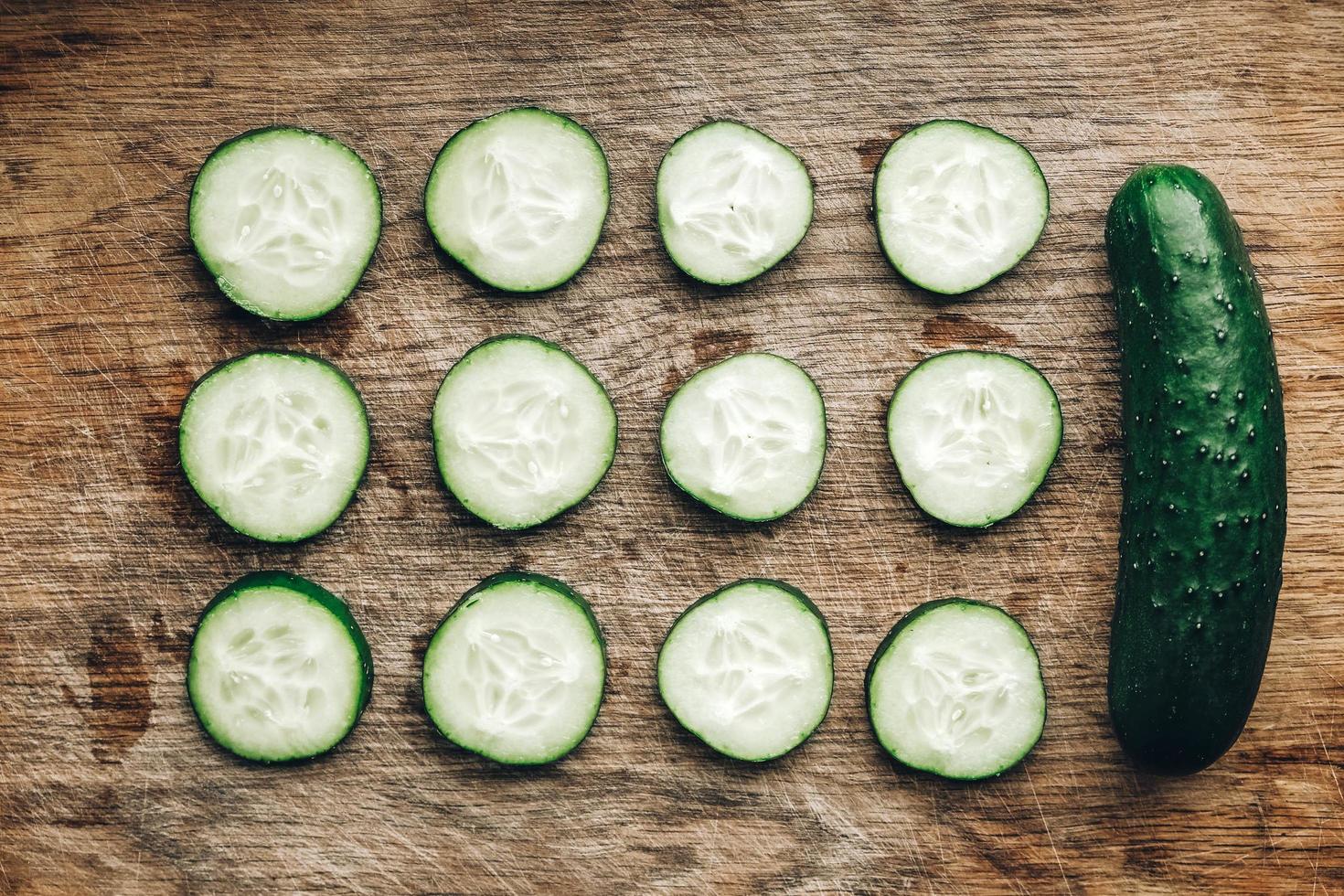 Fresh cucumbers slices on a wooden background. Top view. Copy, empty space for text photo