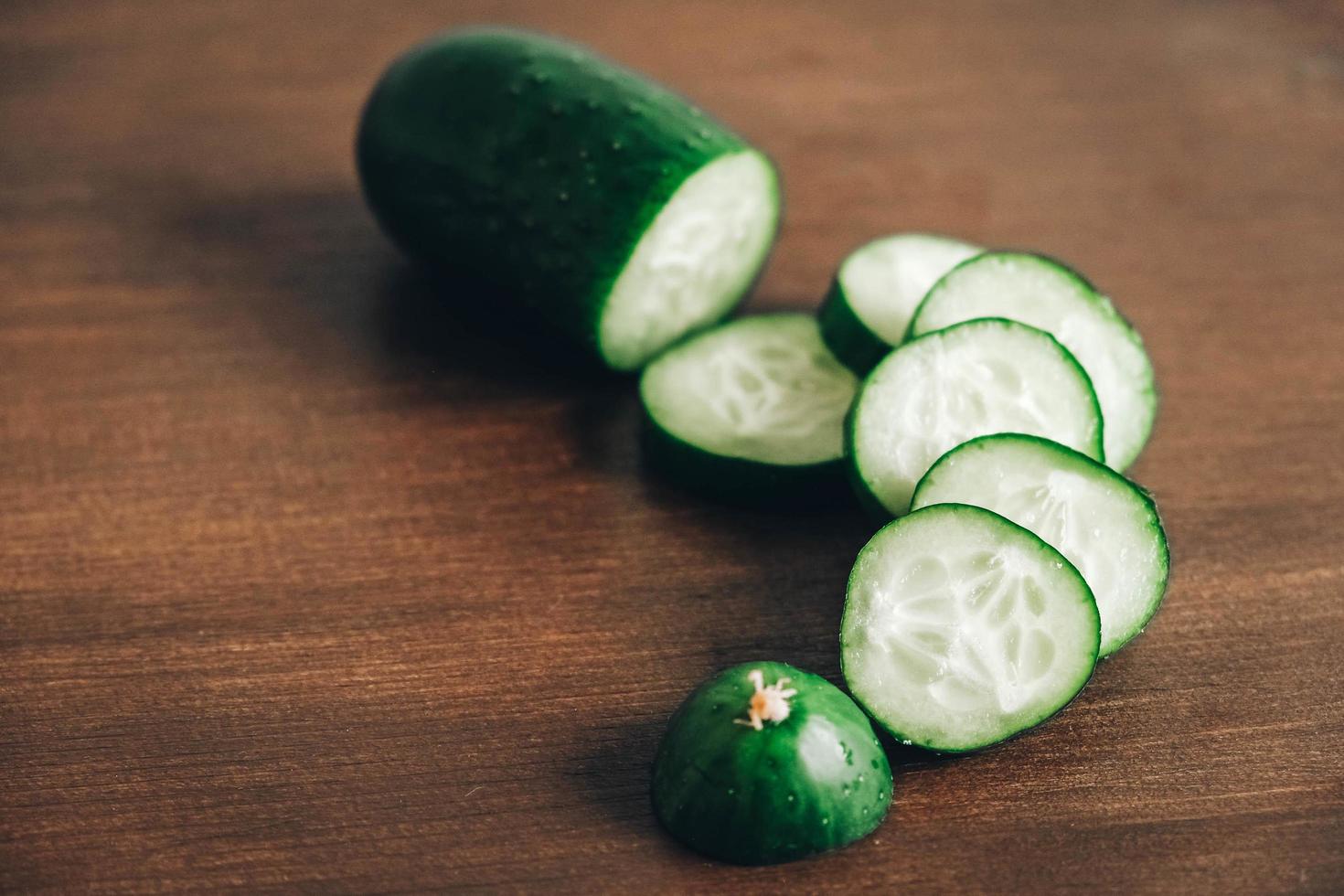 Fresh cucumber slices on a wooden background. Top view. Copy, empty space for text photo