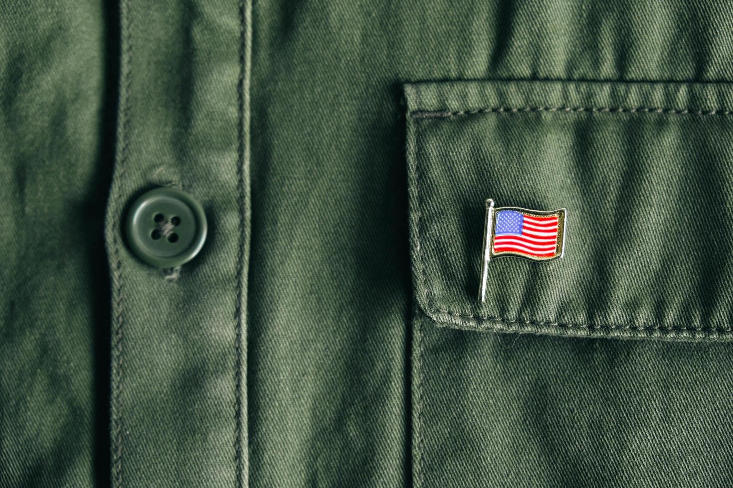 USA flag pin badge on green jacket pocket photo