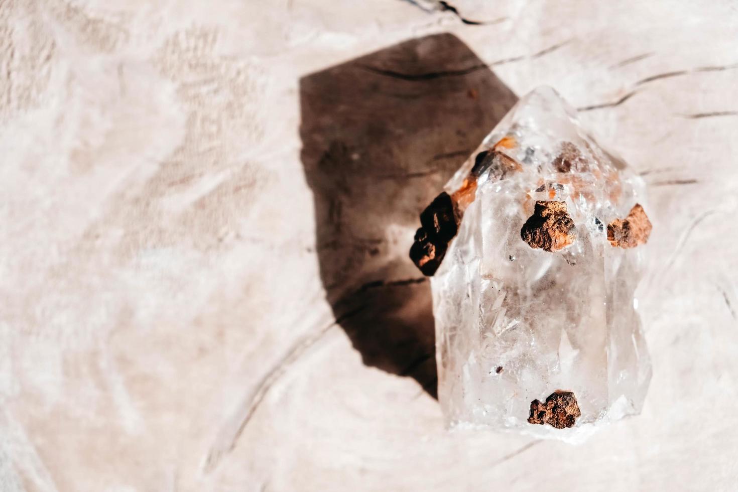 Quartz crystal on a wooden background photo