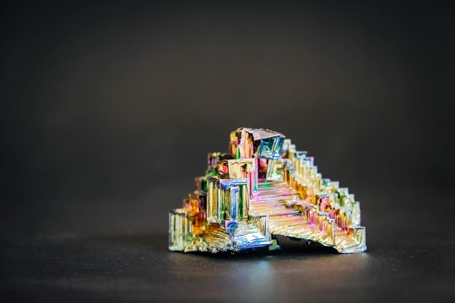 Amazing colorful rainbow Bismuth Gemstone on black background photo