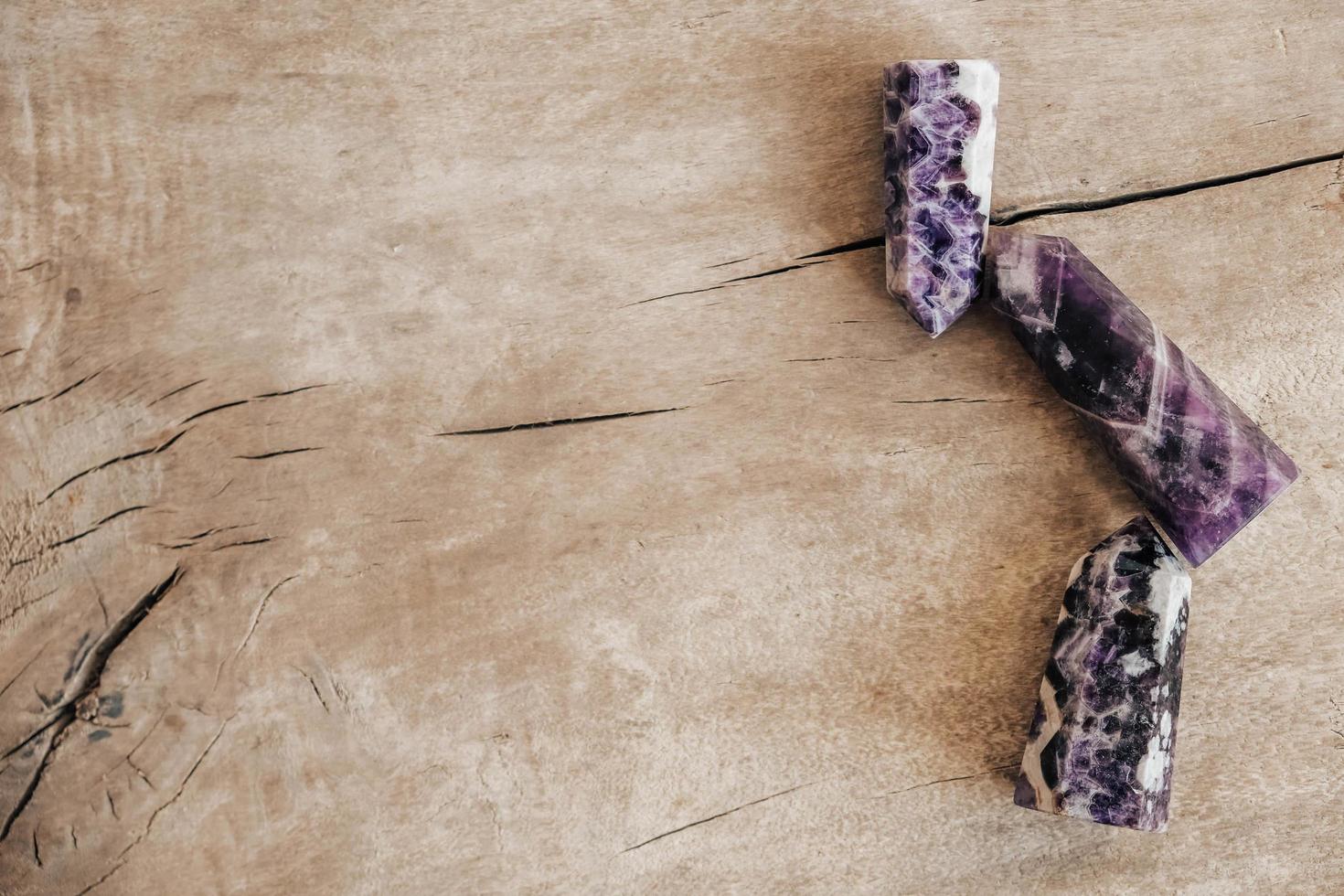 Amethyst polished crystal point on wooden background photo