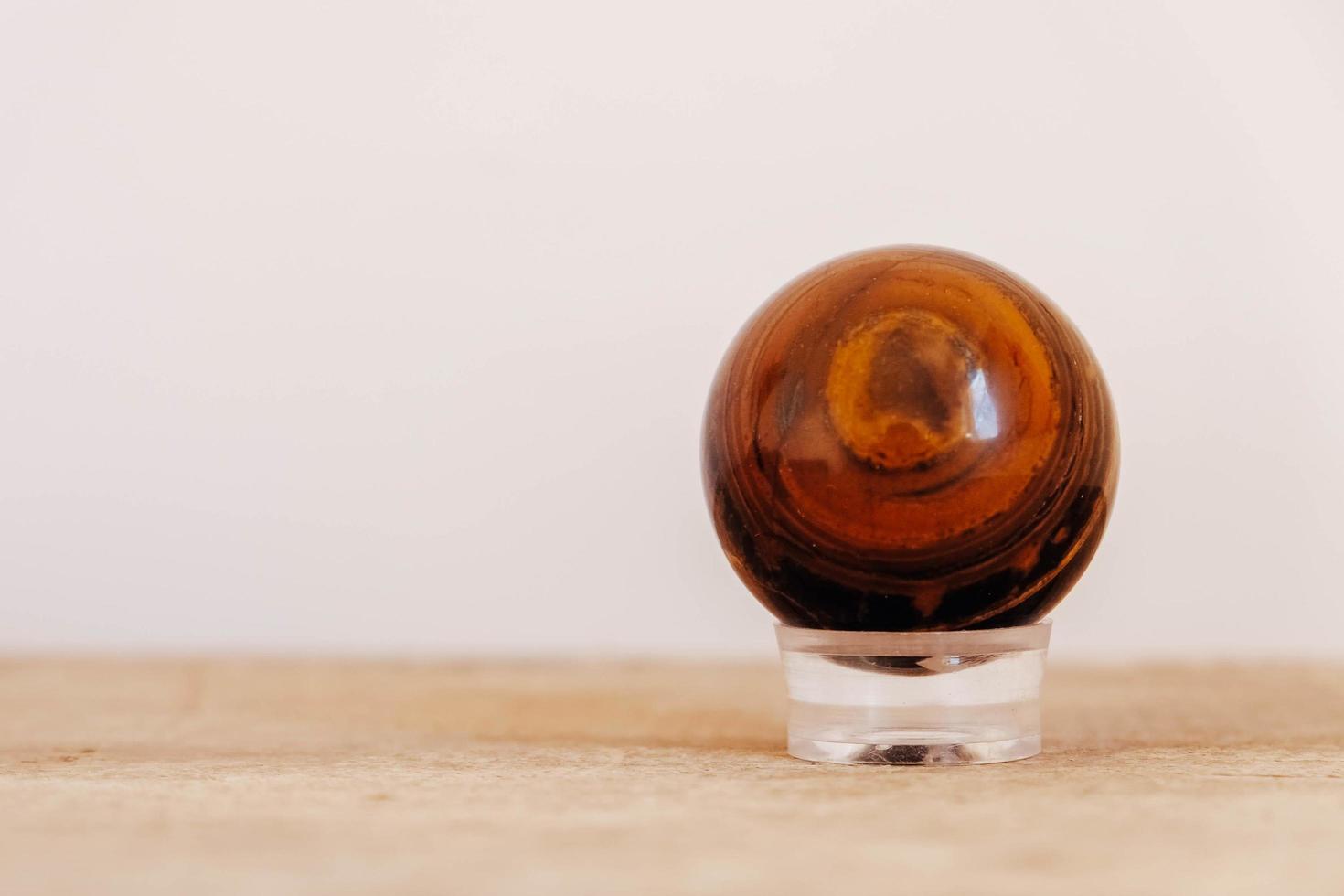 Crystal in the form of ball on a wooden table photo