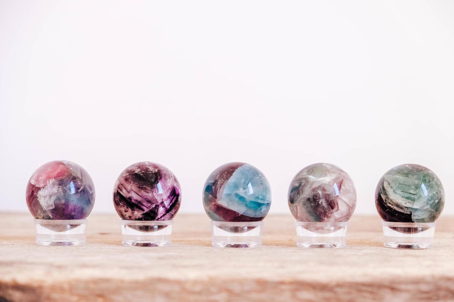 Crystals in the form of balls on a wooden table photo