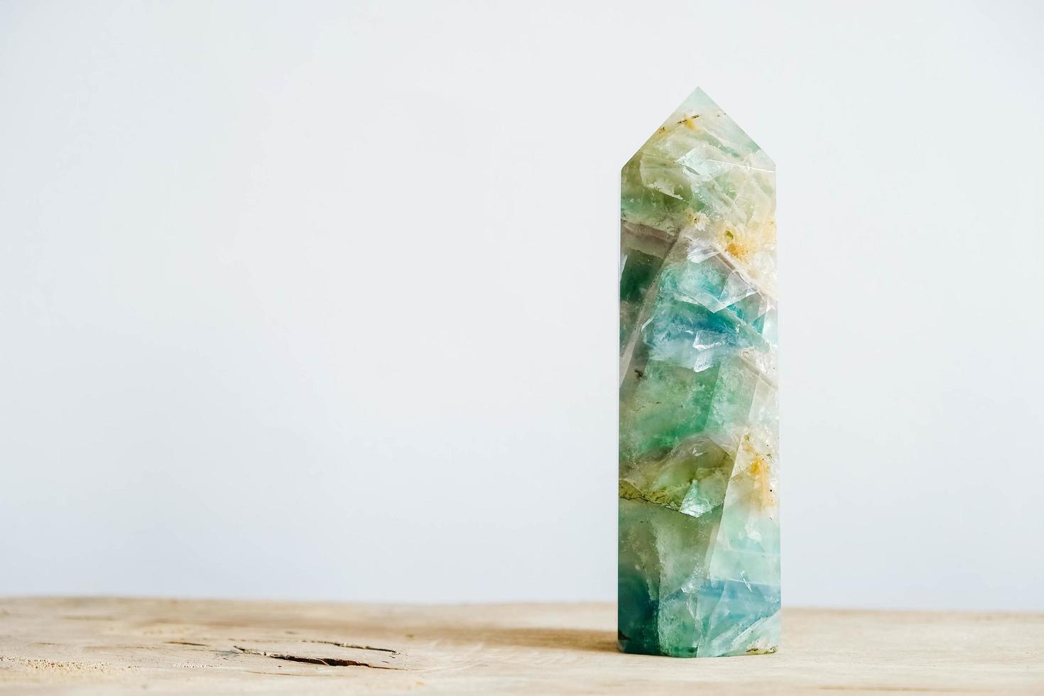 Raw emerald and gemstone rough rock crystal on a wooden table photo