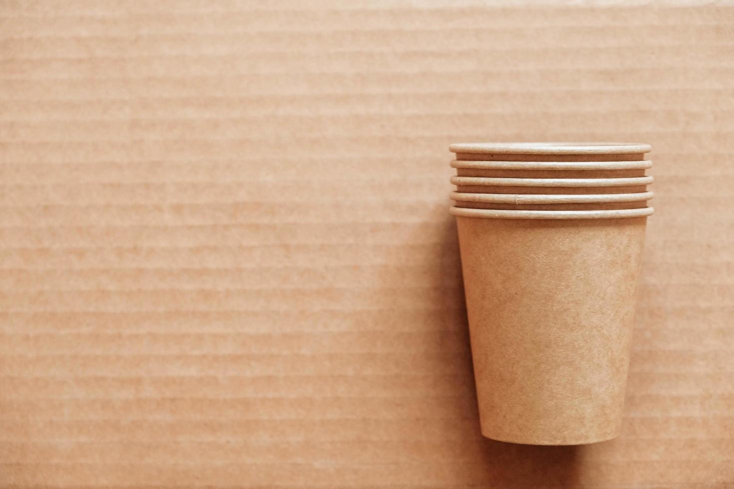 Disposable paper cups on kraft paper background photo