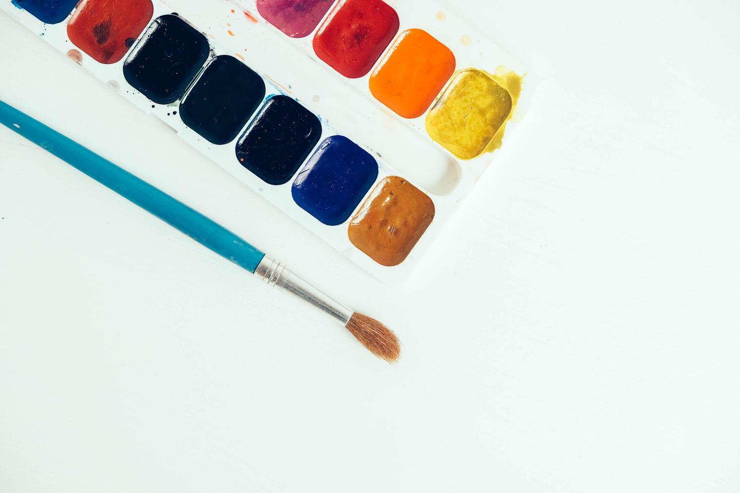 Set of watercolor paints and brush for painting on a white background photo