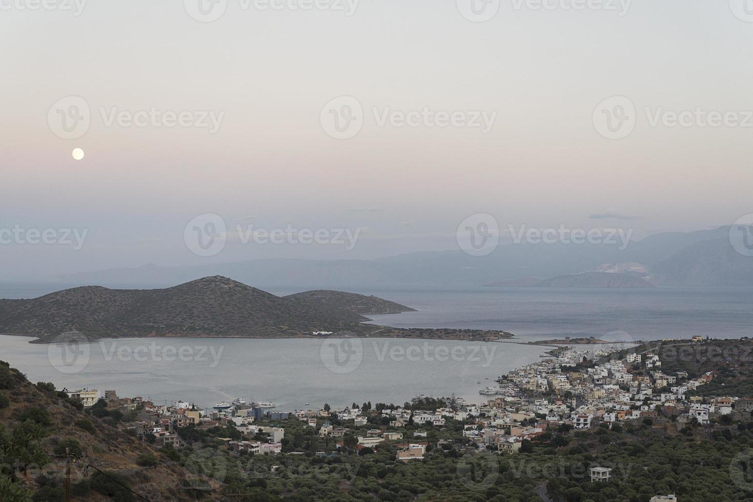 A small town on the shore at sunset. photo