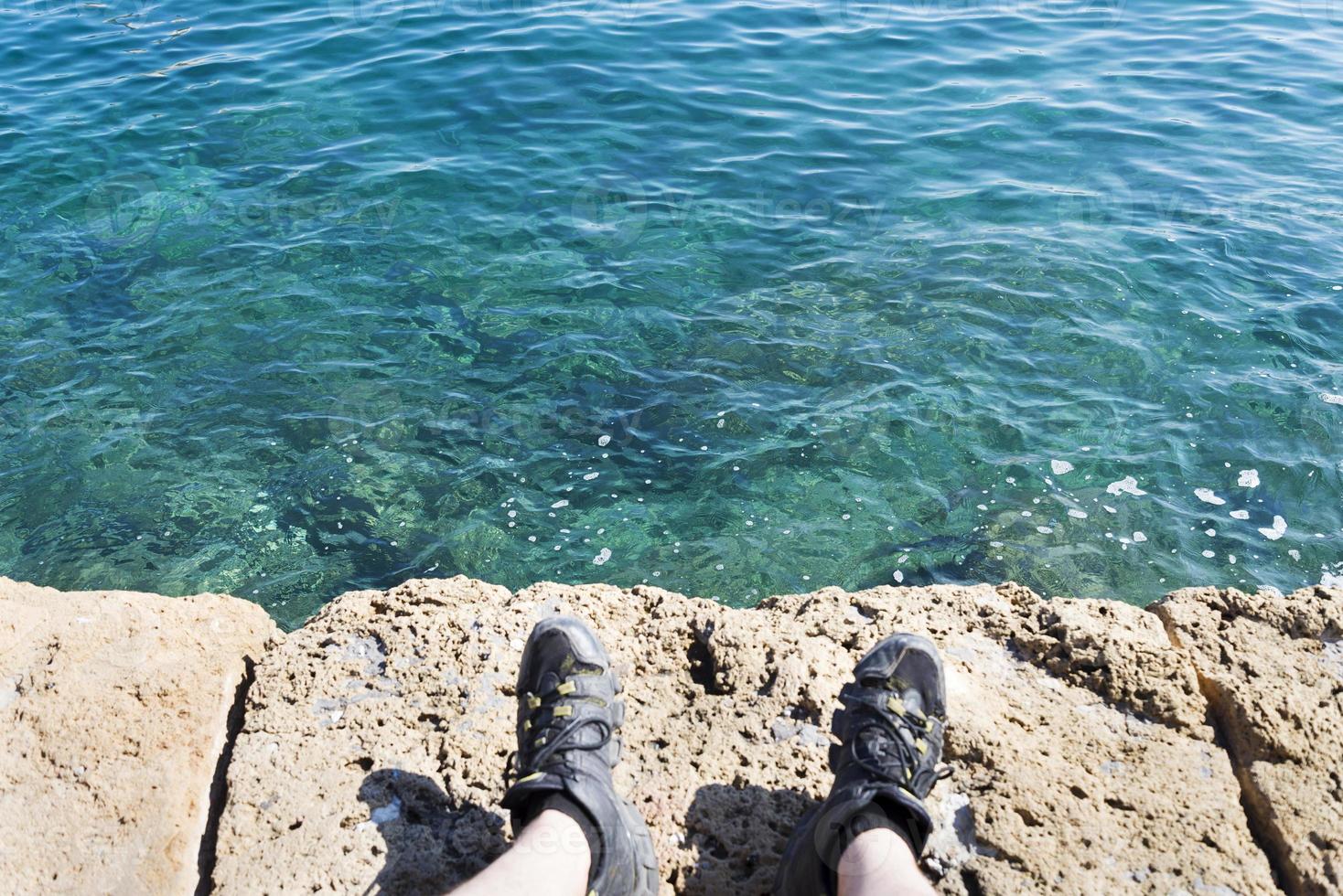 A stone slab near the sea. The texture of the water and stone. photo