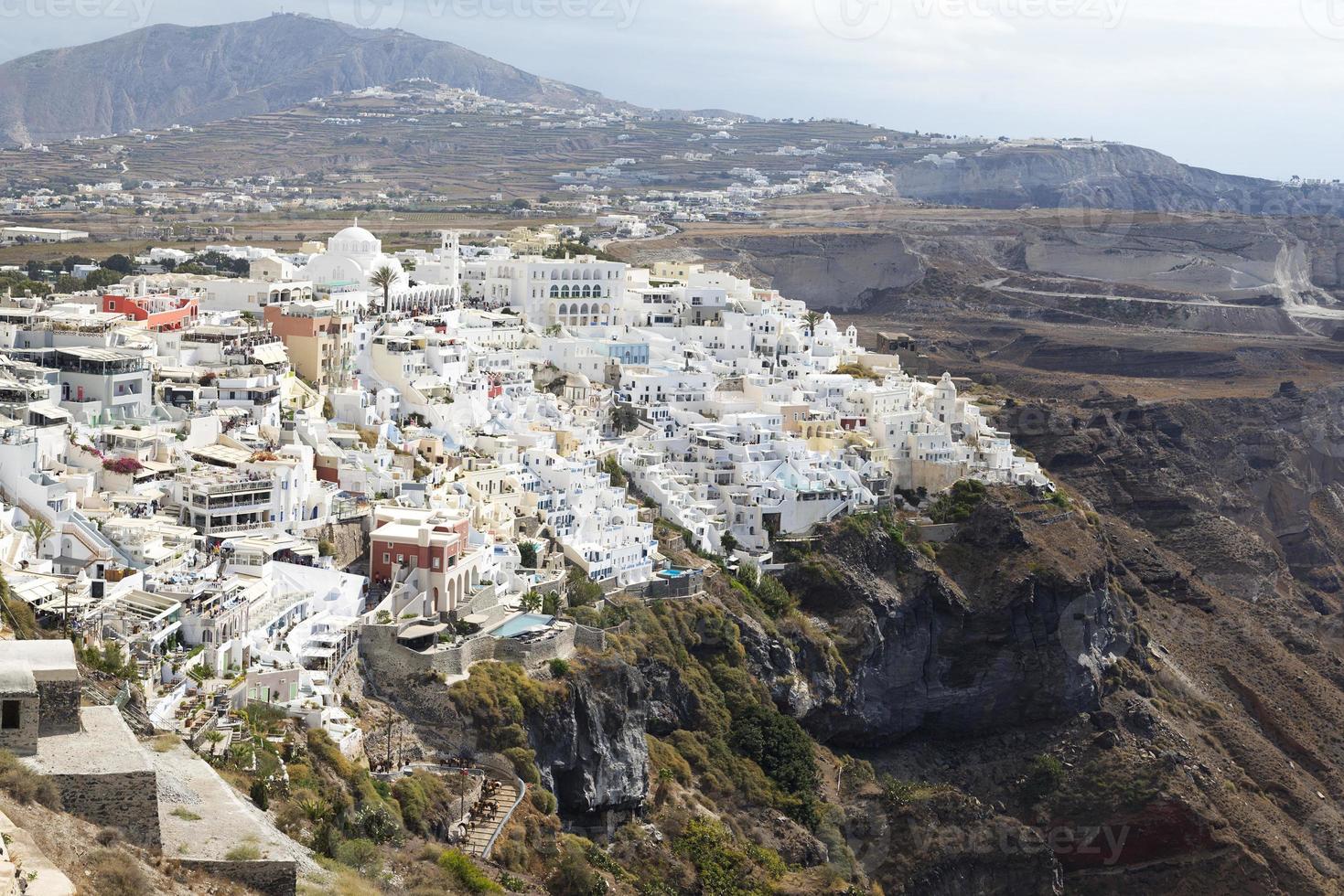 Famous view over the village of Oia at the Island Santorini, Greece photo