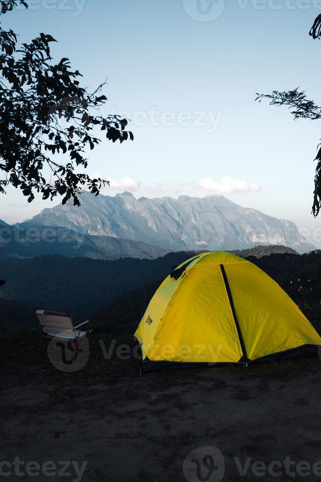 Yellow tent on the mountain and sunset view photo