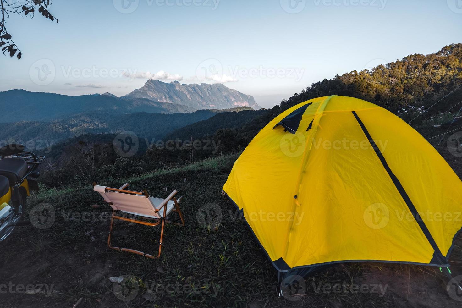 Yellow tent on the mountain and sunset view photo