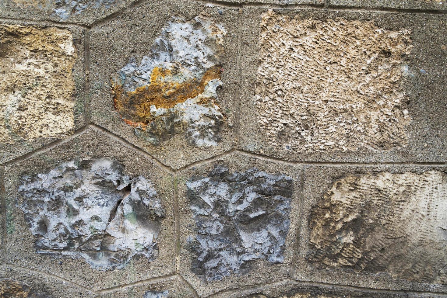 Seamless abstract background. Textured rock wall with various sizes of stones covered by the lichen. The texture of the limestone wall. Stones and lichens as a background. photo