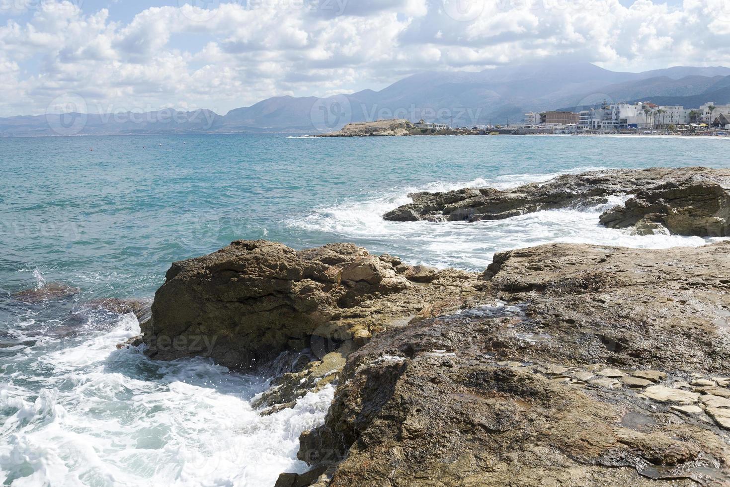 las olas rompiendo en una playa pedregosa, formando un rocío. olas y salpicaduras en la playa. olas rompiendo contra las rocas. foto