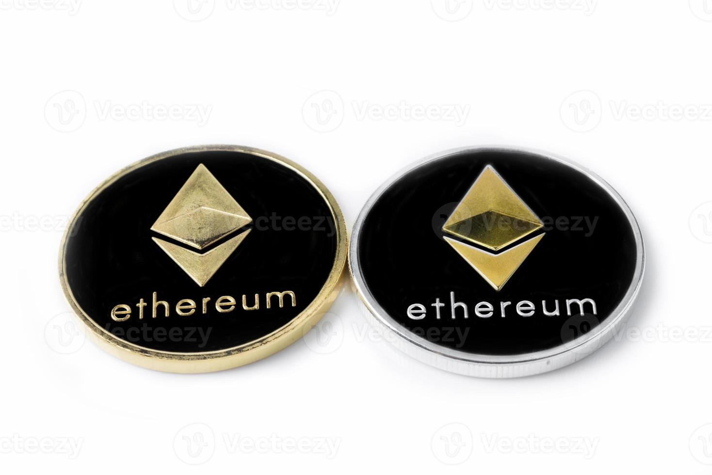Two real coins of silver and golden cryptocurrency Ethereum, isolated on white background photo