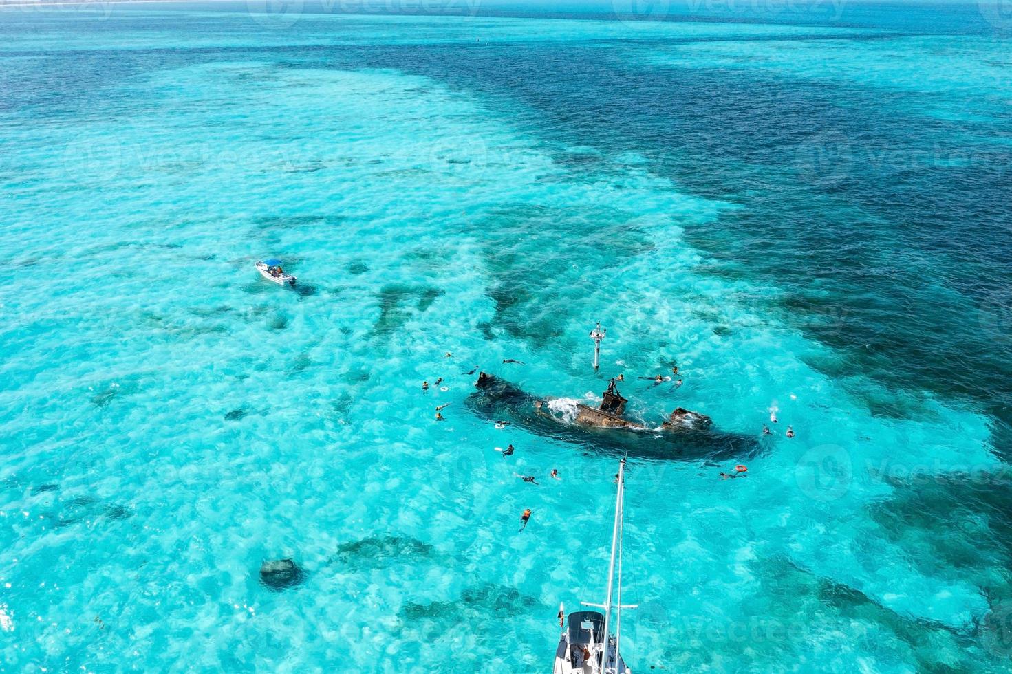 People snorkelling around the ship wreck near Bahamas in the Caribbean sea. photo