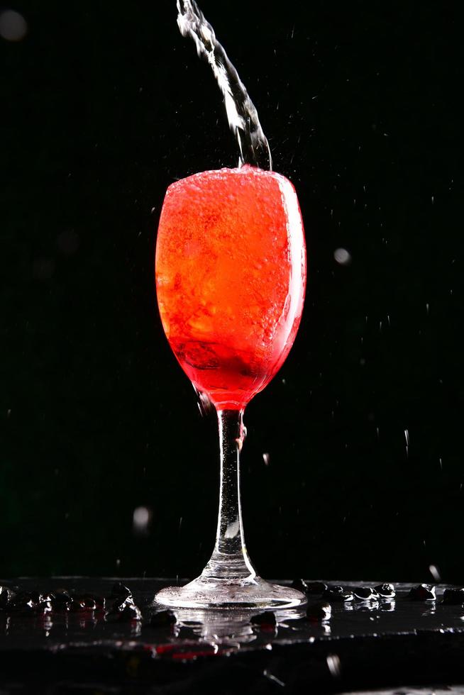 Alcoholic cocktails consisting of red fruit juices and soda water. Poured into a glass of wine by a professional bartender. photo