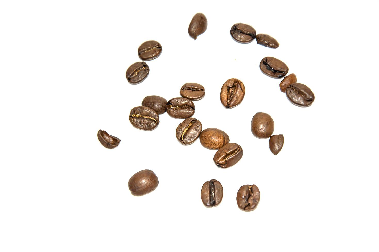 Coffee beans are scattered randomly on a white background. Isolate. Lifestyle photo