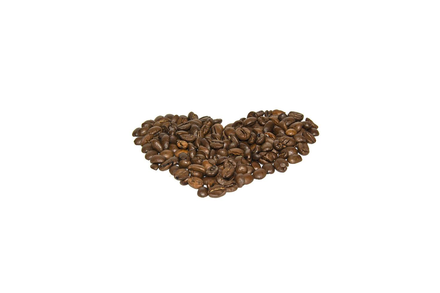 Coffee beans laid out in the shape of a heart on a white background. Isolate. Lifestyle photo