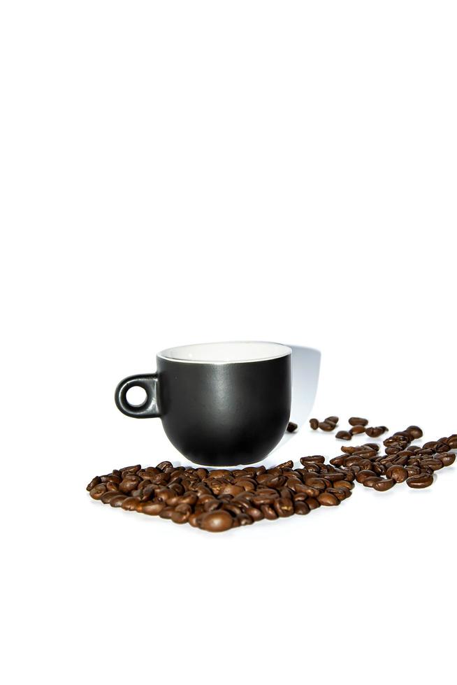 Black heart shaped coffee cup with scattered beans on a white background. Front view. Isolate. Lifestyle. photo