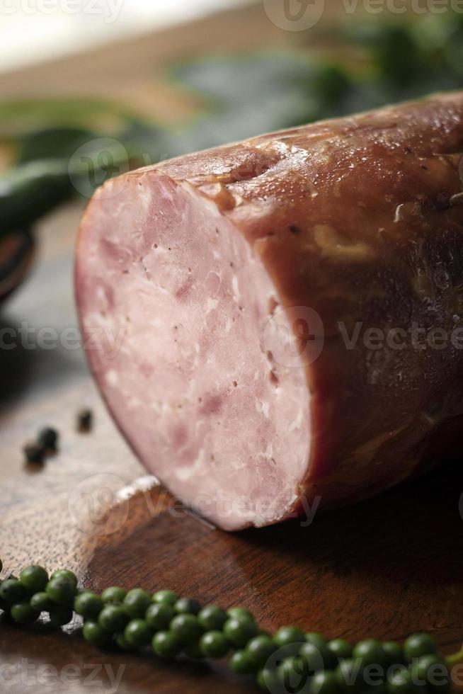 traditional german homemade smoked ham sausage on wood table photo